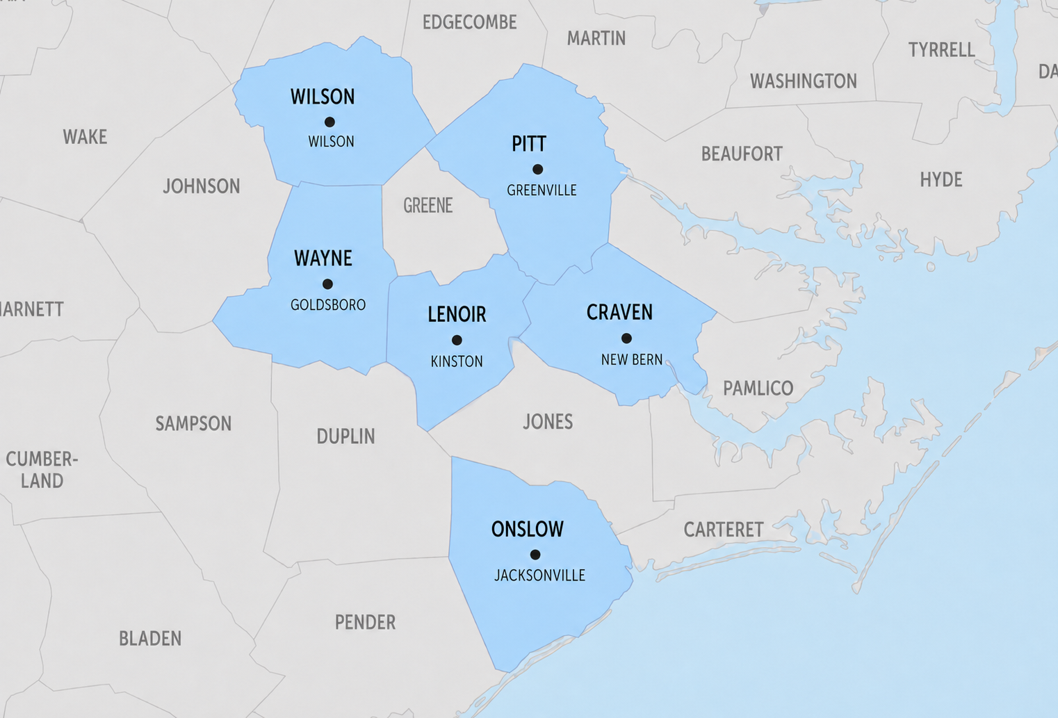 Map of eastern North Carolina with six counties highlighted in blue: Wilson, Pitt, Wayne, Lenoir, Craven, and Onslow, showing county seats Wilson, Greenville, Goldsboro, Kinston, New Bern, and Jacksonville.